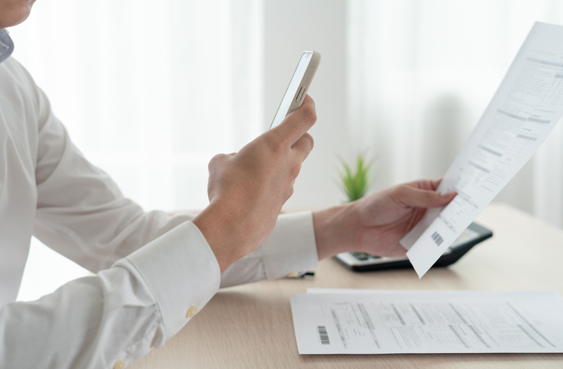 business man use phone to scan barcode or QR codes to pay credit